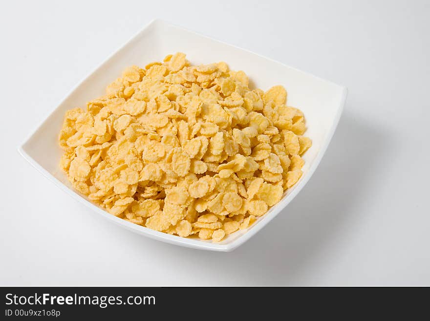 Bowl of flakes on white