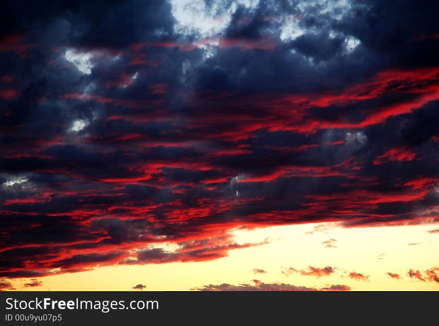 Fall shiny red sunset clouds and the earth