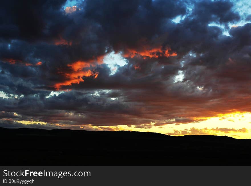 Fall shiny red sunset clouds and the earth