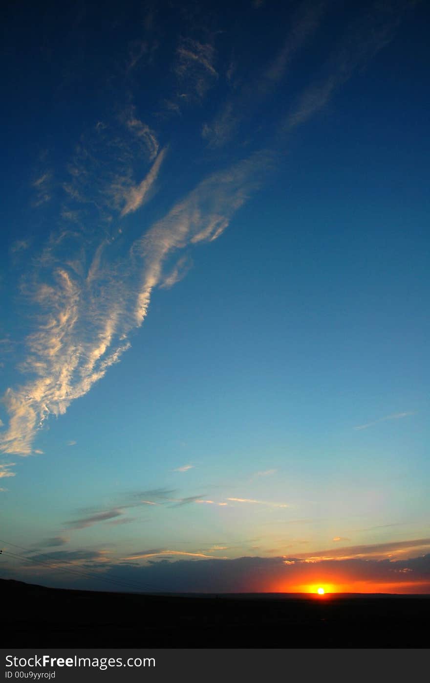 Fall shiny red sunset clouds and the earth