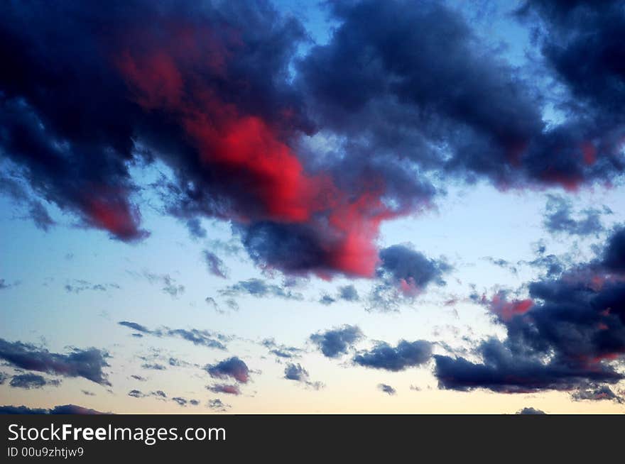 Fall shiny red sunset clouds and the earth