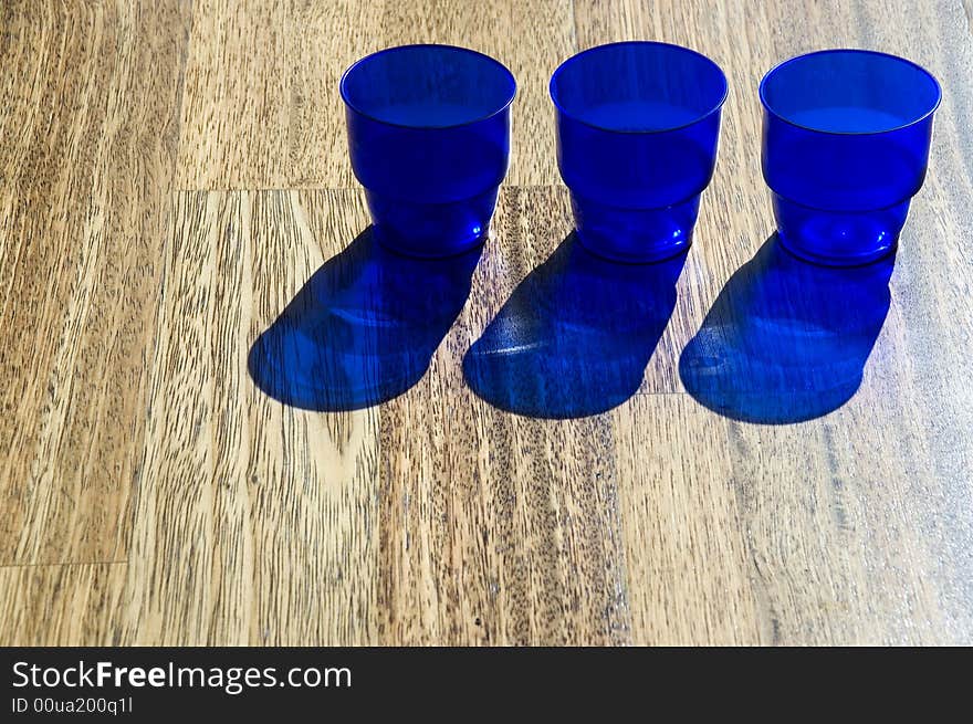 Dark blue utensils, shadow on a floor. Dark blue utensils, shadow on a floor.