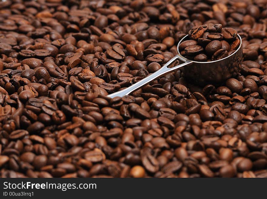 Coffee spoon lying on coffee beans. Coffee spoon lying on coffee beans