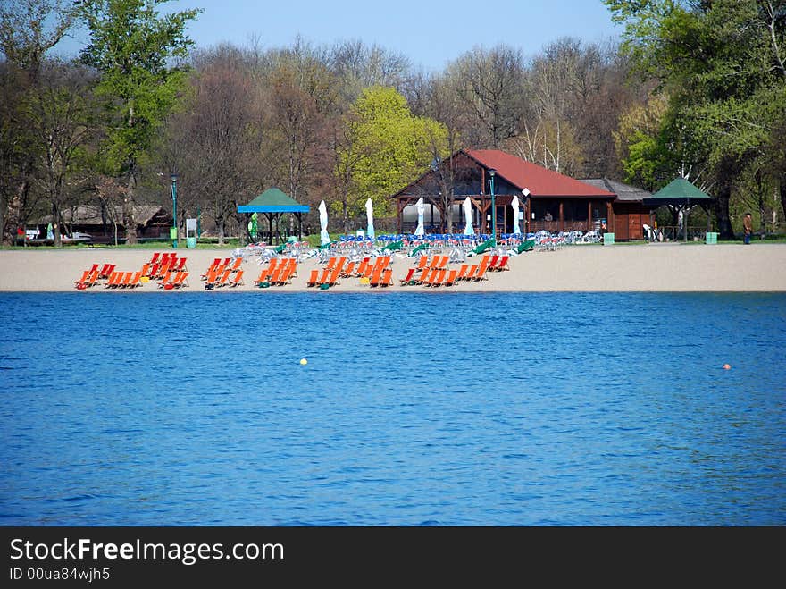 Empty orange folding chairs on bank in park cafe. Empty orange folding chairs on bank in park cafe