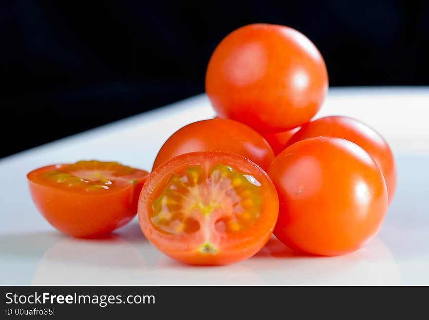 Fresh cherry- tomatoes on a white plate