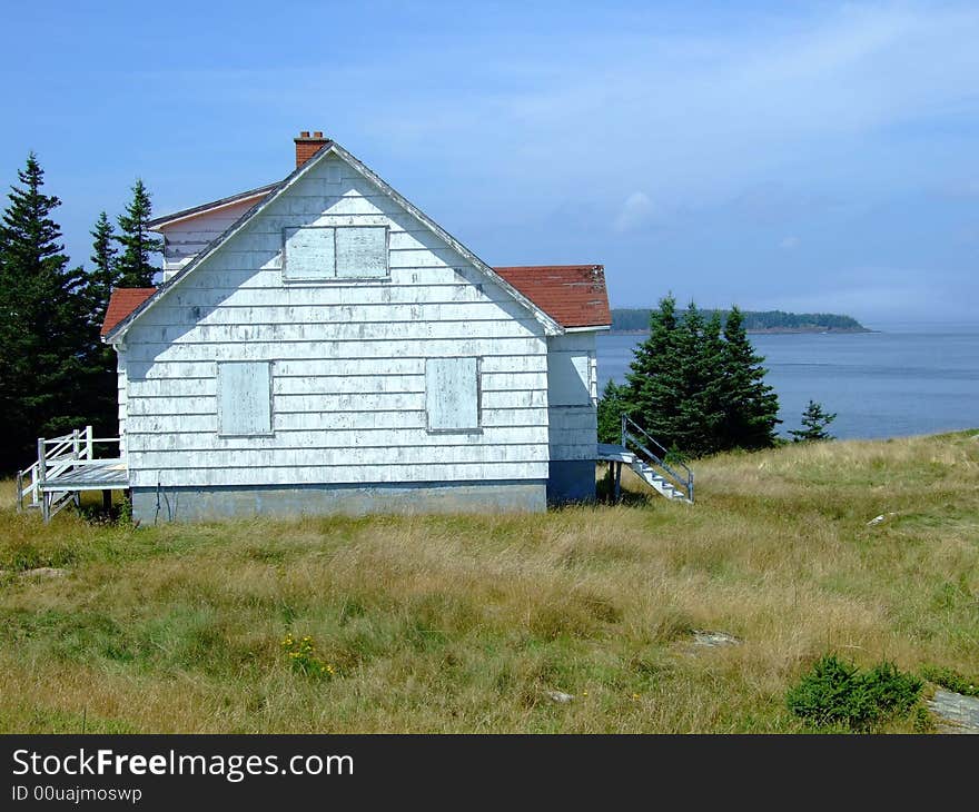 Old abandoned boarded up house, on Moshers Island Lighthouse Lahave Lunenburg County Nova Scotia Canada. Old abandoned boarded up house, on Moshers Island Lighthouse Lahave Lunenburg County Nova Scotia Canada