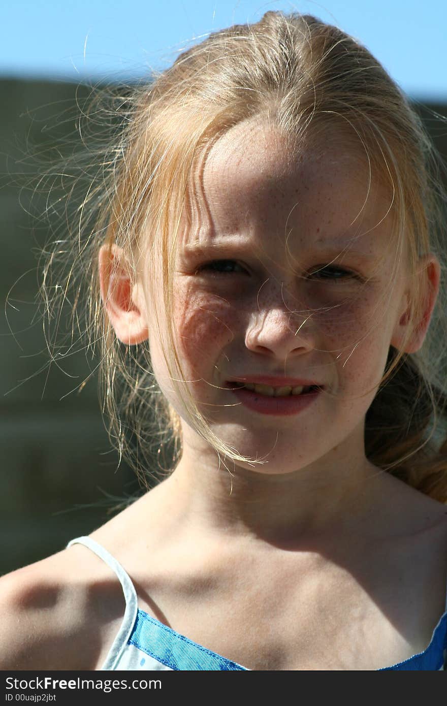 A little white caucasian girl with a worried expression on her face. A little white caucasian girl with a worried expression on her face