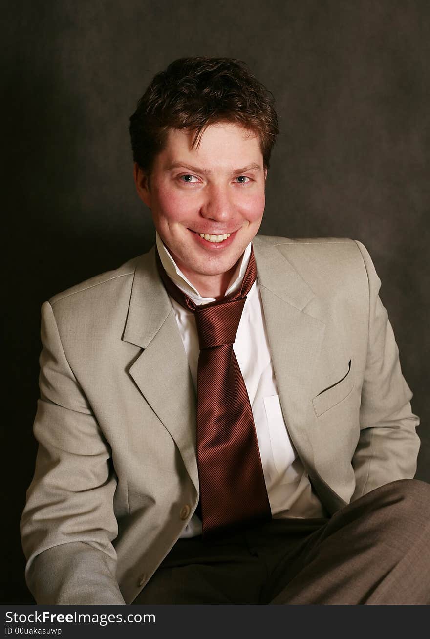 Smiling man in studio on a black background