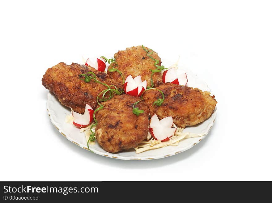 Meat rissoles with garden radish on a white round plate