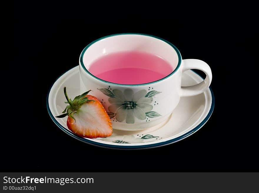 A cup of tea which made from strawberry. A cup of tea which made from strawberry