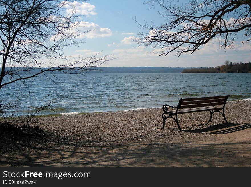 Parkbench at a lake on a sunny afternoon. Parkbench at a lake on a sunny afternoon