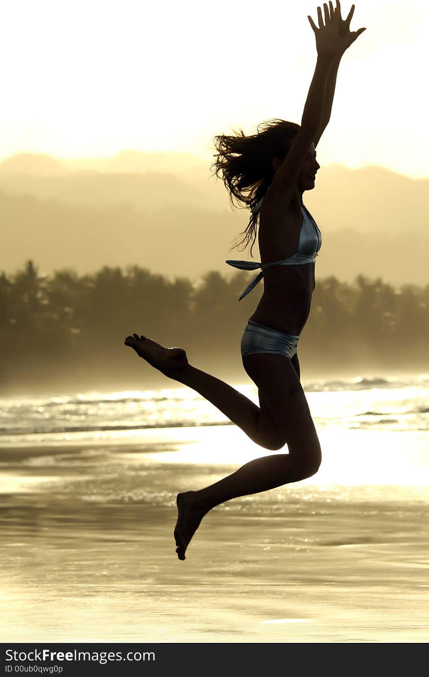 Woman in bikini jumping on the beach. Woman in bikini jumping on the beach