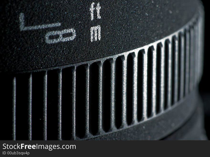 The distance scale and focusing ring of an interchangeable lens. The distance scale and focusing ring of an interchangeable lens.