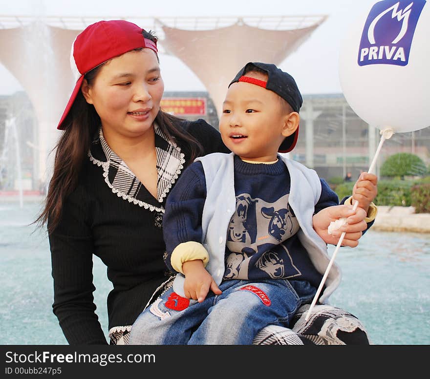 A Chinese mother and his little son,hugging. A Chinese mother and his little son,hugging.