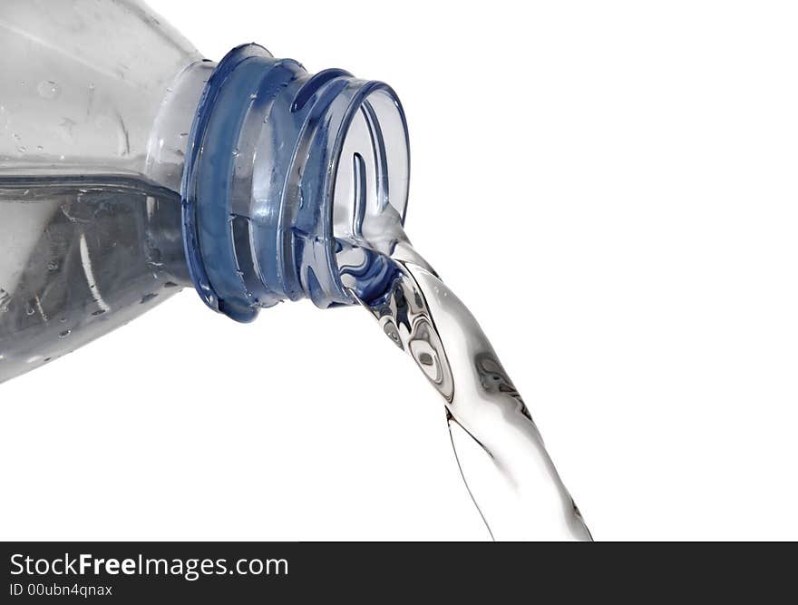 Fresh mineral water pouring from of a bottle