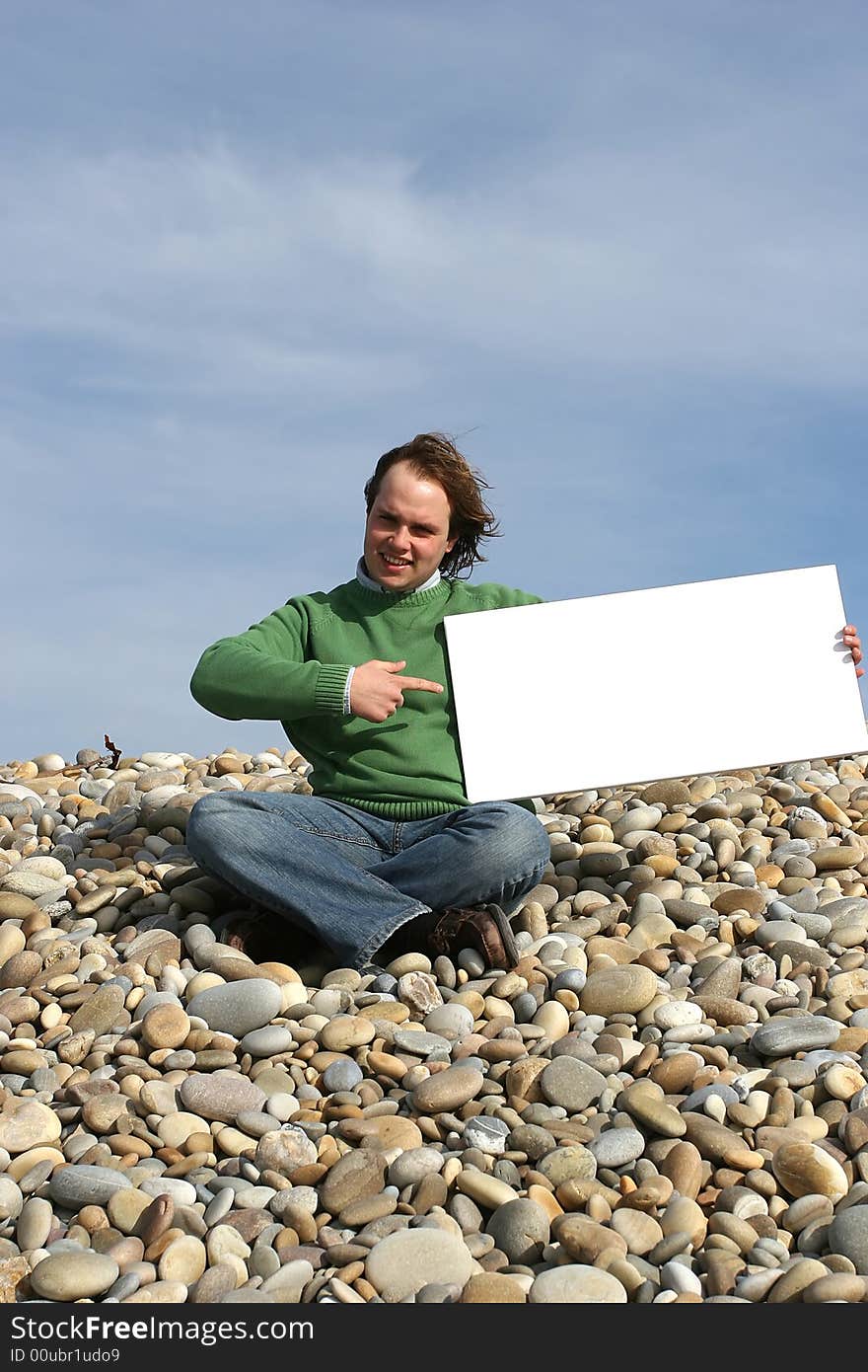 Young Man Holding White Card at the beach