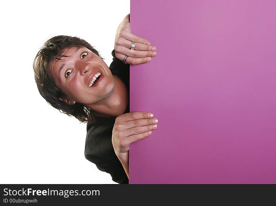 Attractive young man holding a purple billboard, studio shot. Attractive young man holding a purple billboard, studio shot