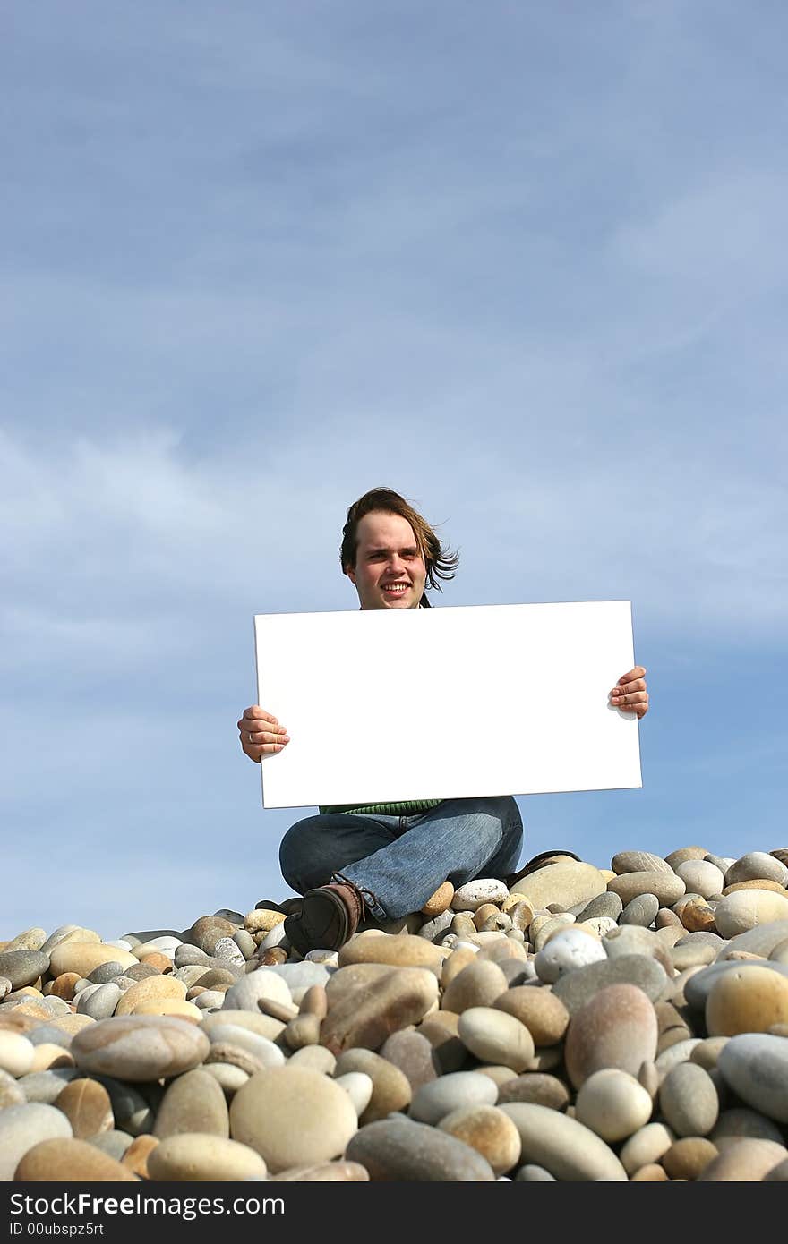 Young Man Holding White Card at the beach