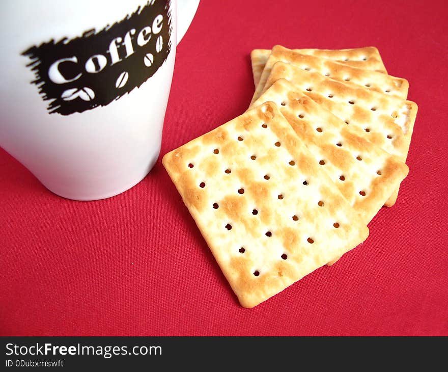 Coffee with crackers in red background. Coffee with crackers in red background.