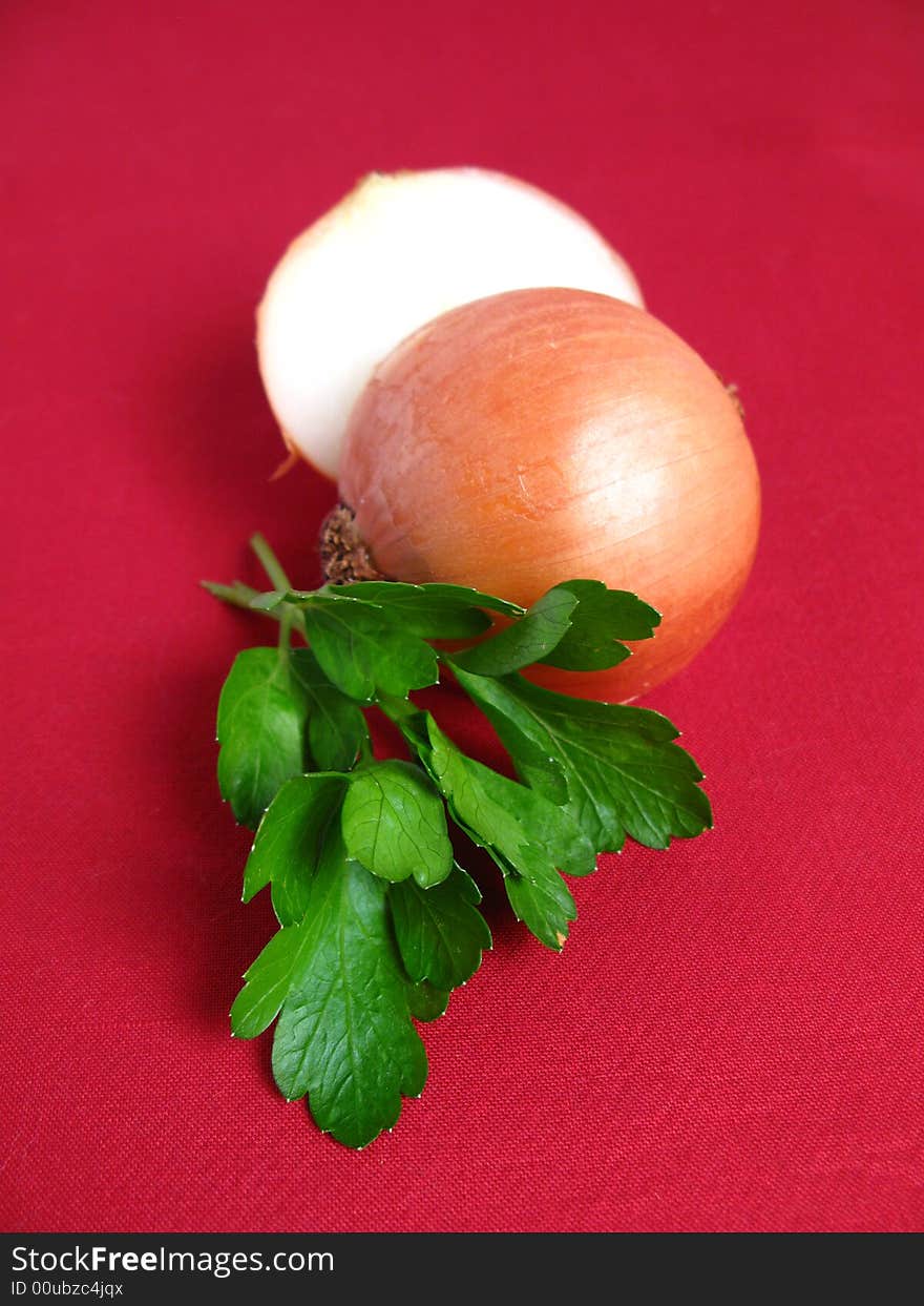 Bouquet of parsley tied with a white rope, Onion and Garlic, in red background. Bouquet of parsley tied with a white rope, Onion and Garlic, in red background.