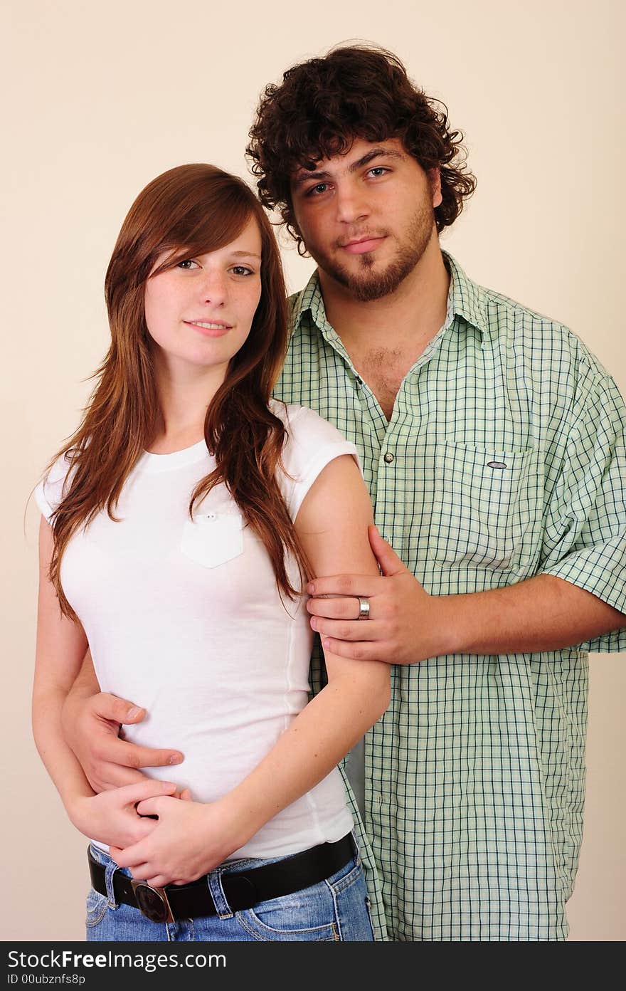 Young couple - boy hugging girl from behind. Young couple - boy hugging girl from behind.