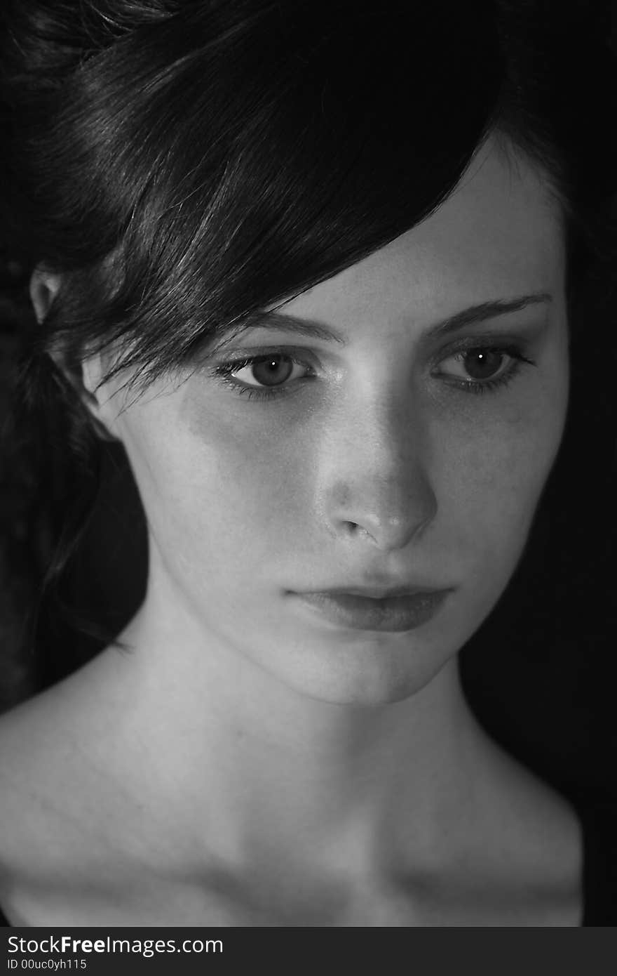 A black and white portrait of a young woman with a thoughtful expression. A black and white portrait of a young woman with a thoughtful expression.