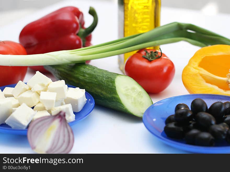 Multi-coloured vegetables for salad on a white background