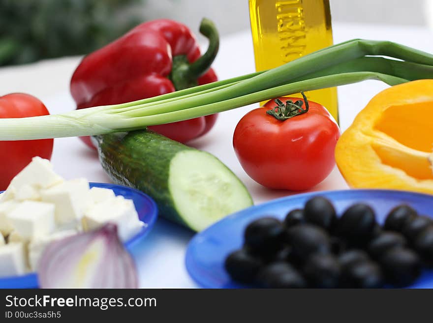 Multi-coloured vegetables for salad on a white background