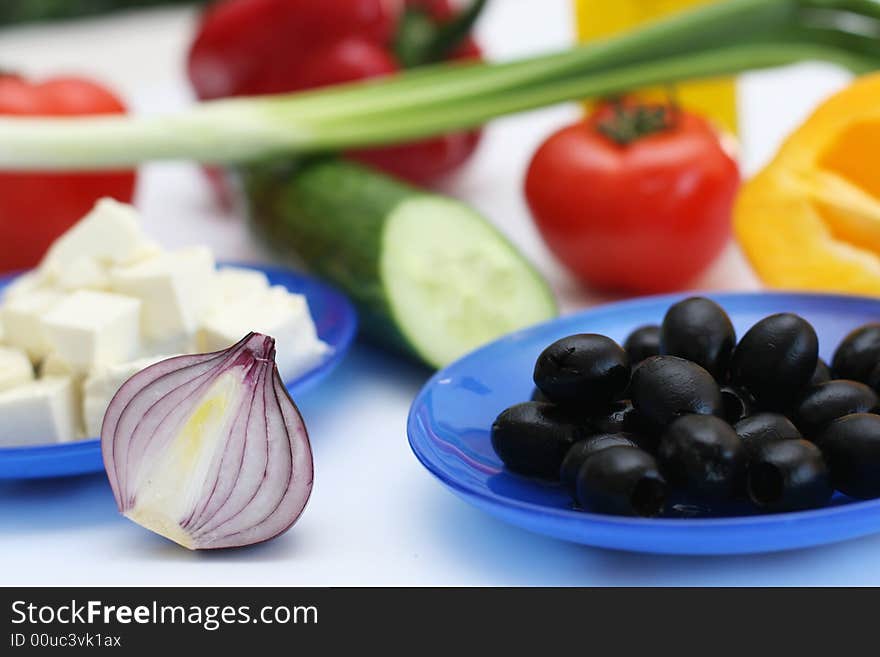 Multi-coloured vegetables for salad on a white background