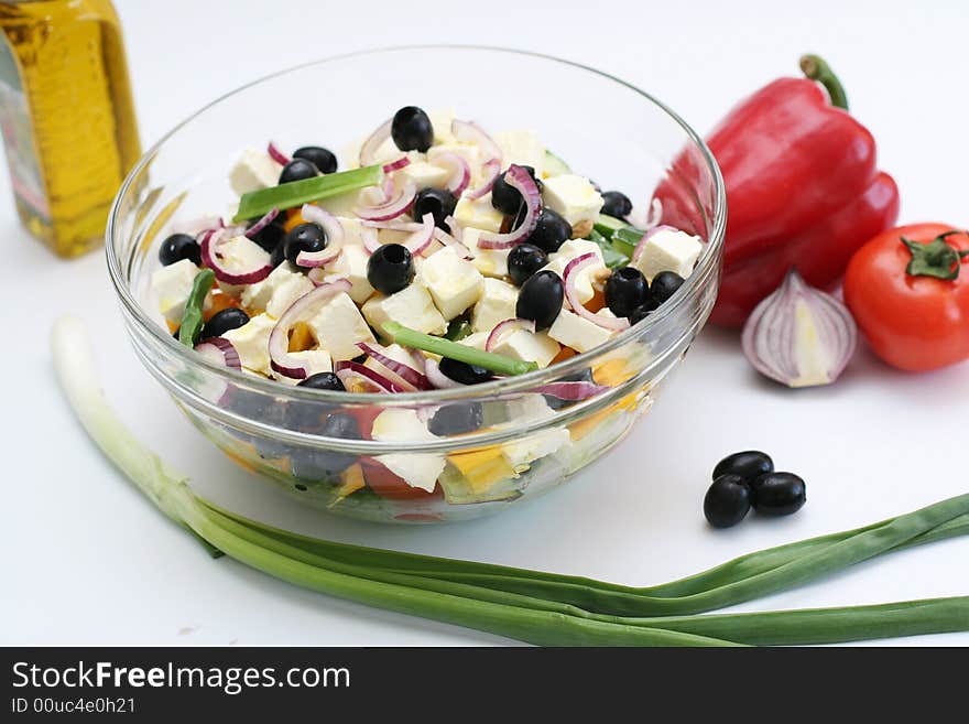 Multi-coloured vegetables for salad on a white background