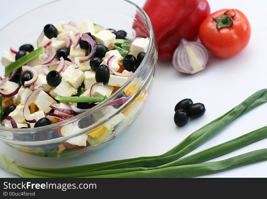 Multi-coloured vegetables for salad on a white background