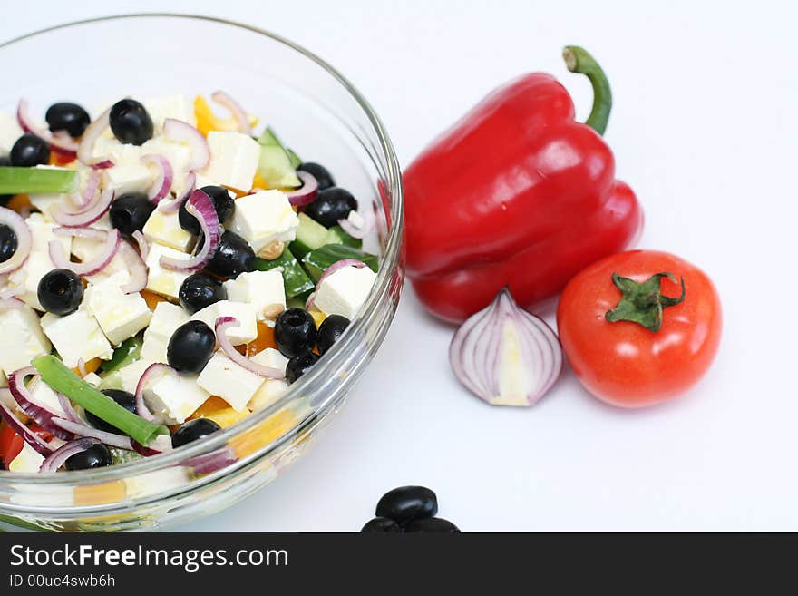 Multi-coloured vegetables for salad on a white background