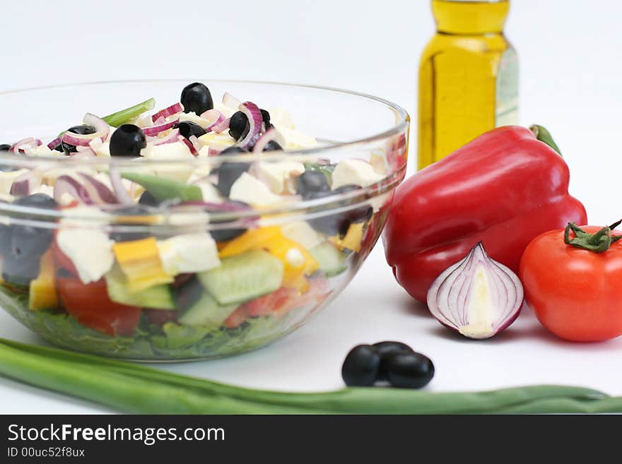 Multi-coloured vegetables for salad on a white background