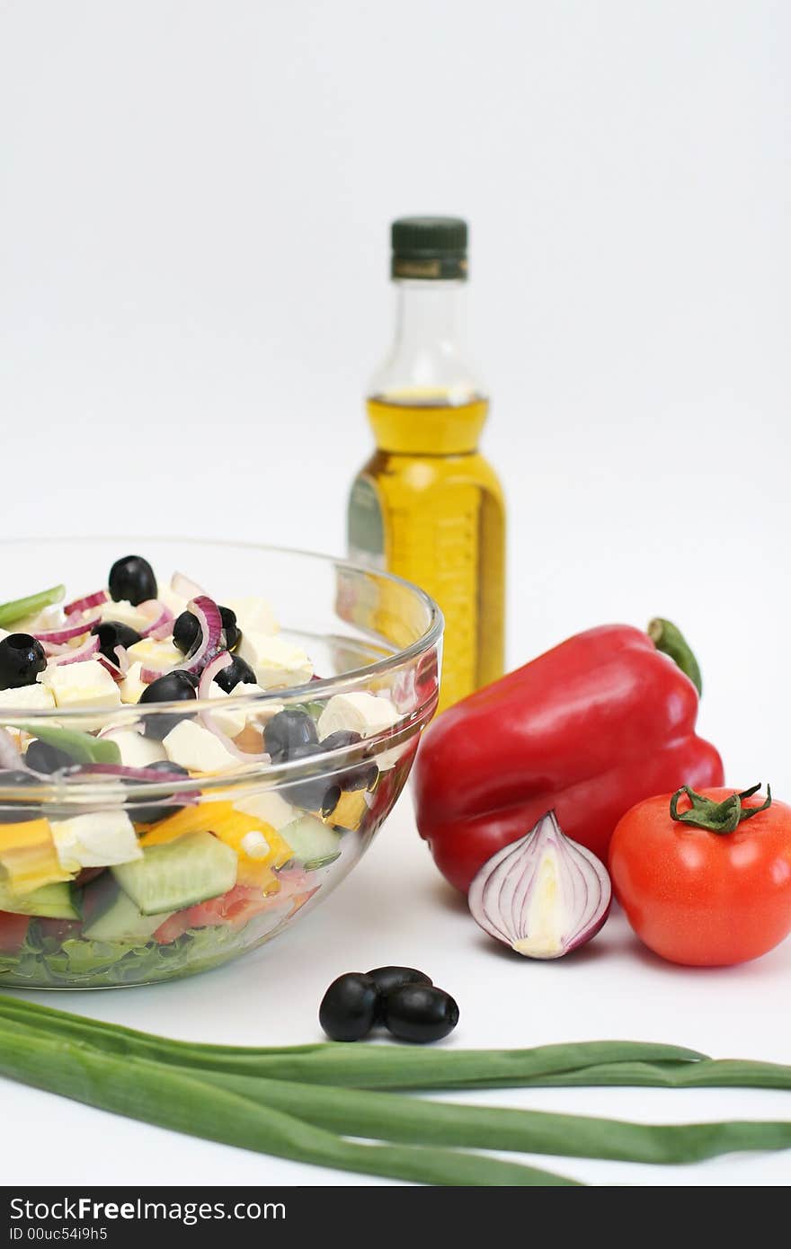 Multi-coloured vegetables for salad on a white background