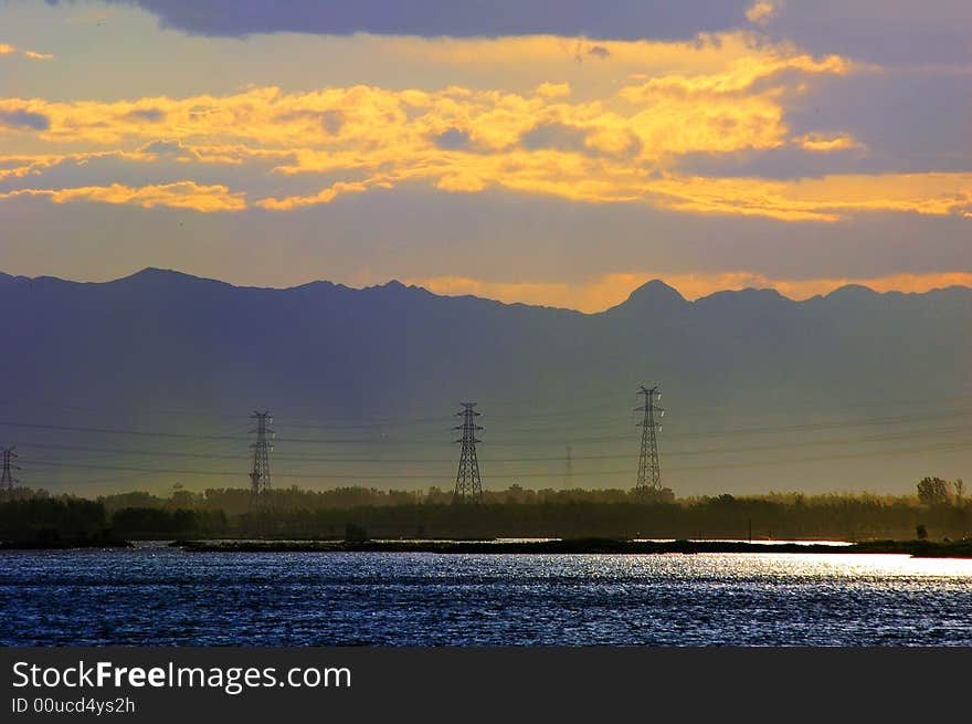 Before sunset the lake color change light blue,  the telegraph pole suddenly appeared. Before sunset the lake color change light blue,  the telegraph pole suddenly appeared