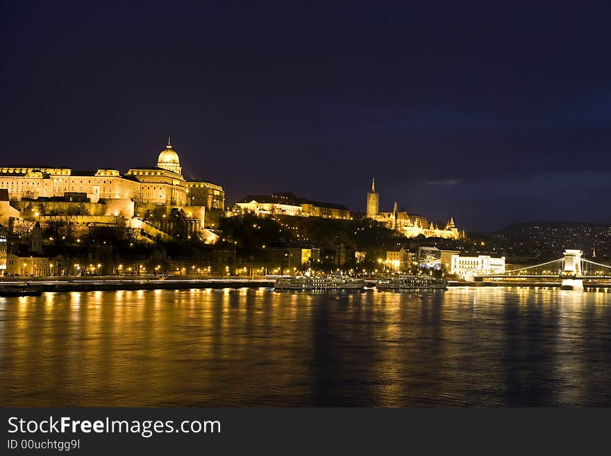 Budapest at night, th e Royal palace, behind the Matthias church and the Chainbridge