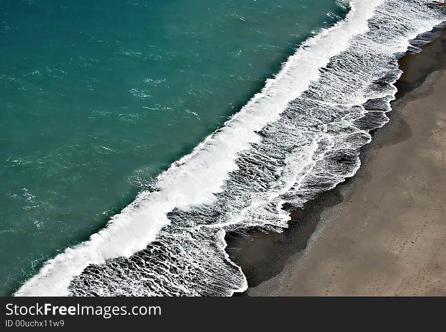 Waves rushing to the seashore taken seventy meters above