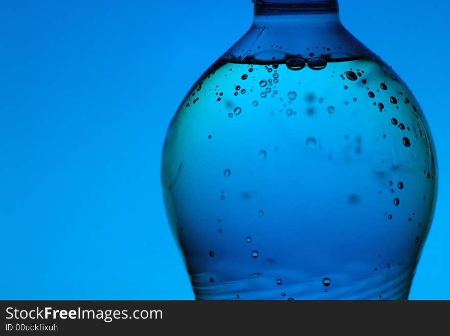 Mineral water bottle on blue background