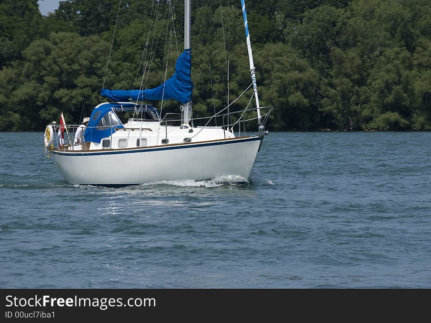 A white-hulled Canadian boat motoring on the Niagara river at the height of summer. A white-hulled Canadian boat motoring on the Niagara river at the height of summer.