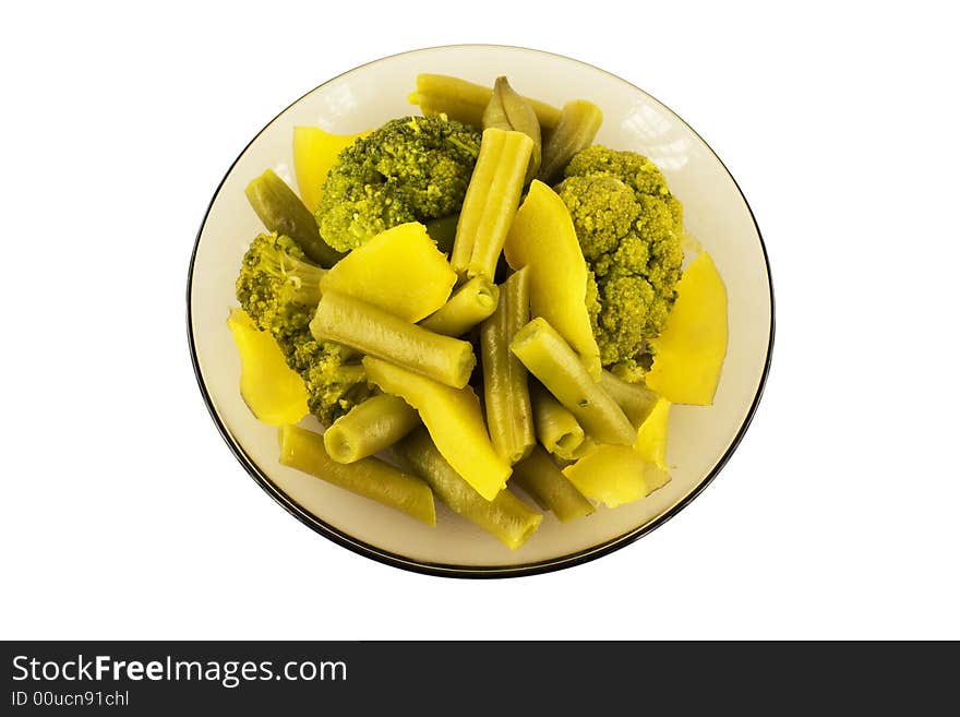 Steamed string beans, vegetable marrow and broccoli on a plate, isolated. Steamed string beans, vegetable marrow and broccoli on a plate, isolated