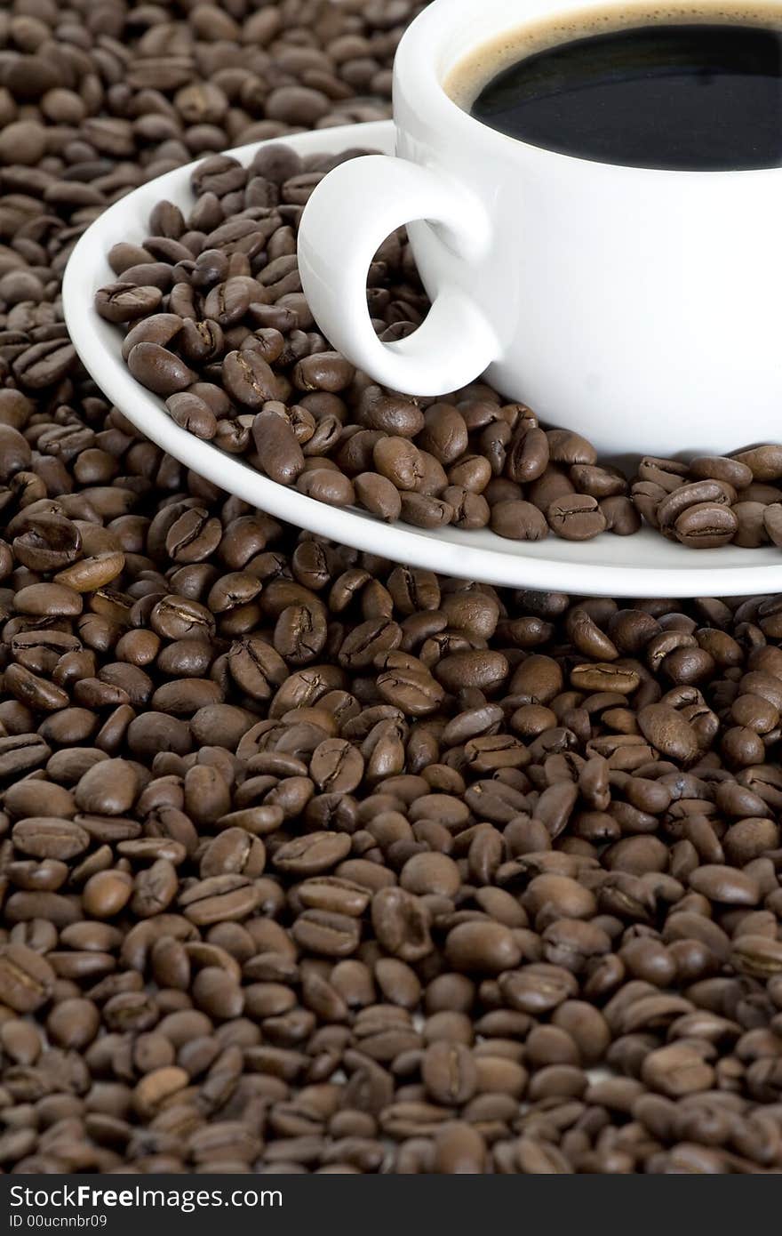 Cup of coffee view from above and coffee beans background. Cup of coffee view from above and coffee beans background