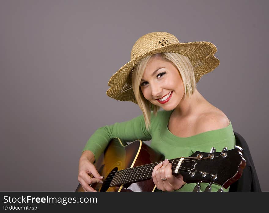 Blonde Playing Guitar and Smiling