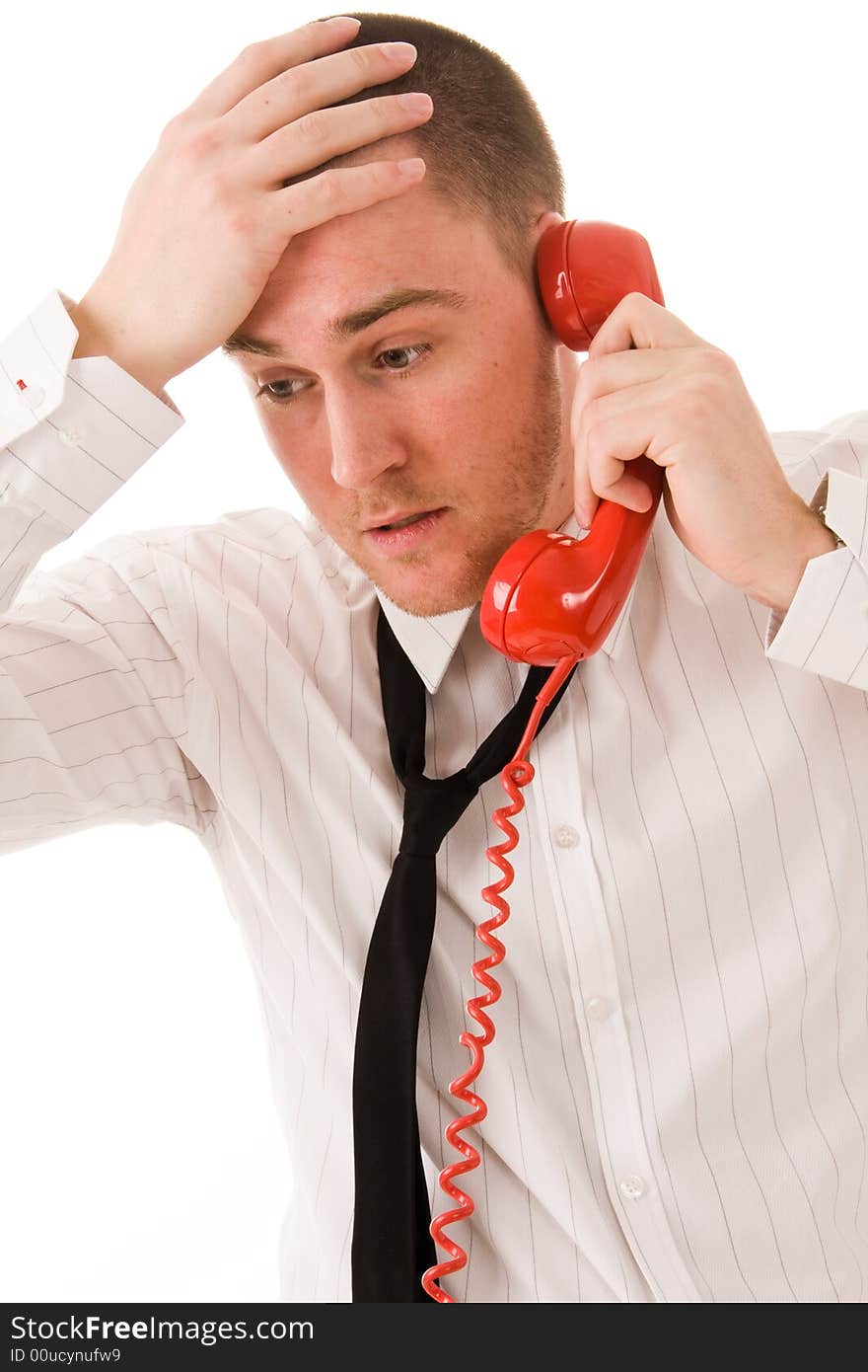 Young handsome businessman and red telephone receiver