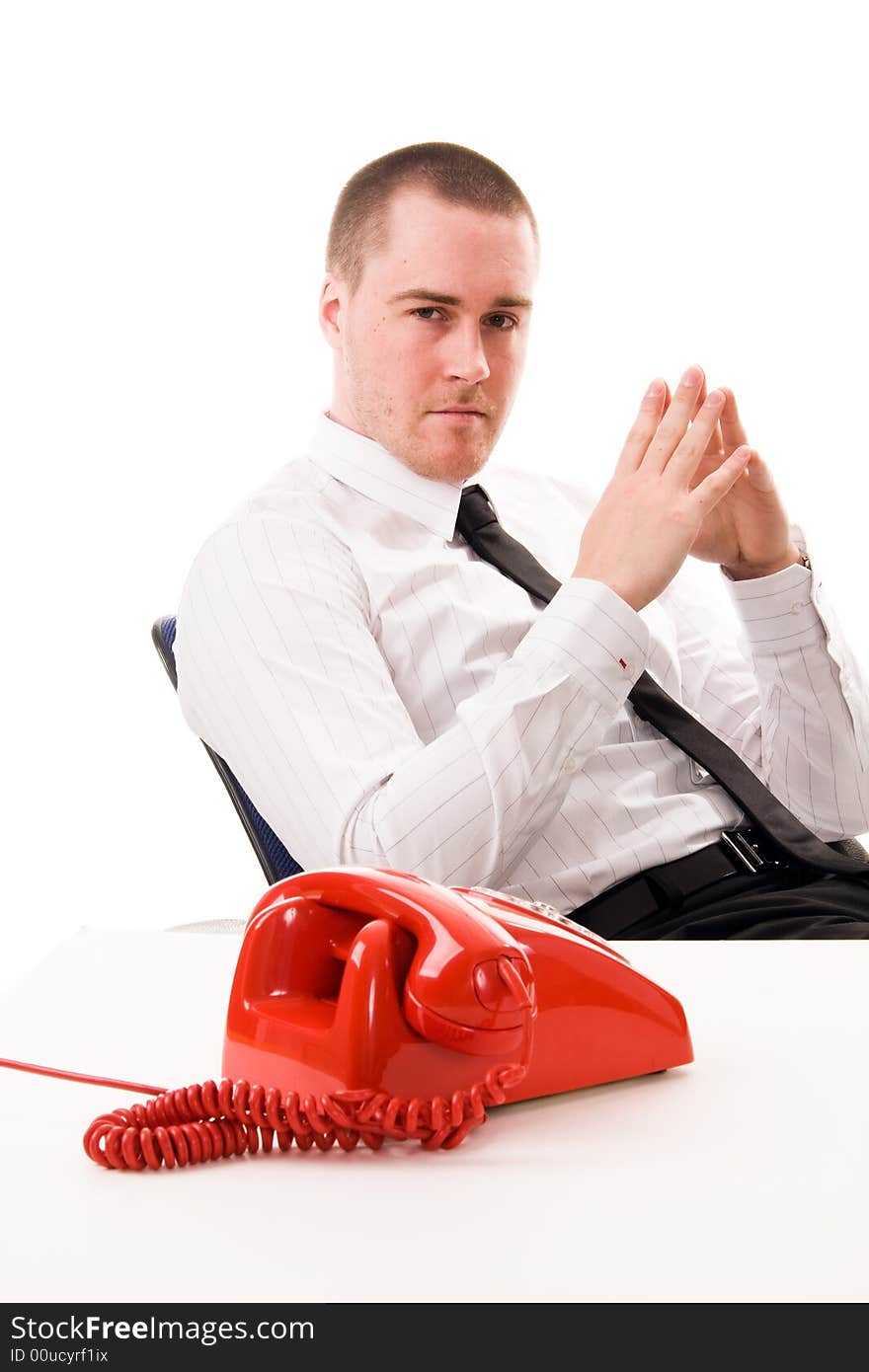 Young handsome businessman and red telephone