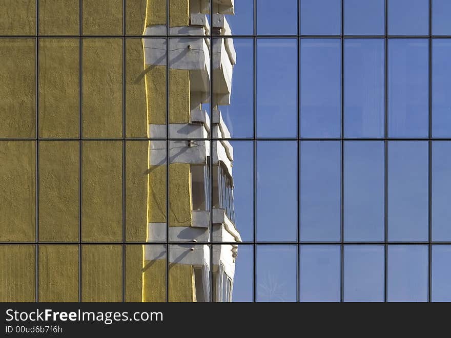 Reflexion of the old, yellow building in the glass wall of modern office park skyscraper. Reflexion of the old, yellow building in the glass wall of modern office park skyscraper.