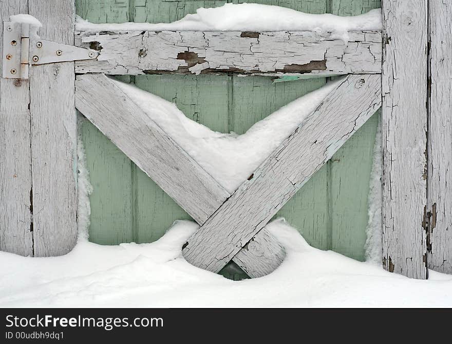 Snow drifted against part of an old door. Snow drifted against part of an old door