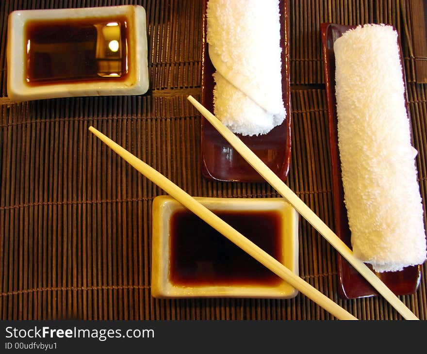 Sushi table sticks sauce white towels. Sushi table sticks sauce white towels