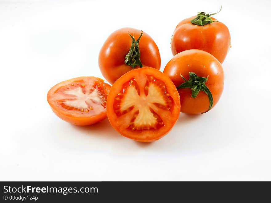 Red Tomatoes and slice on white background