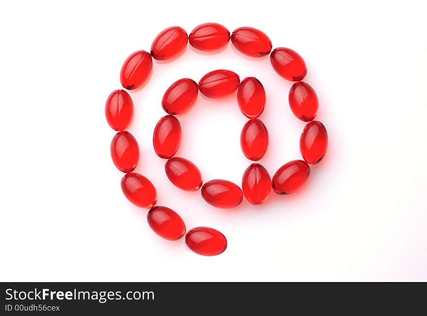 At Symbol Made Of Red Capsules