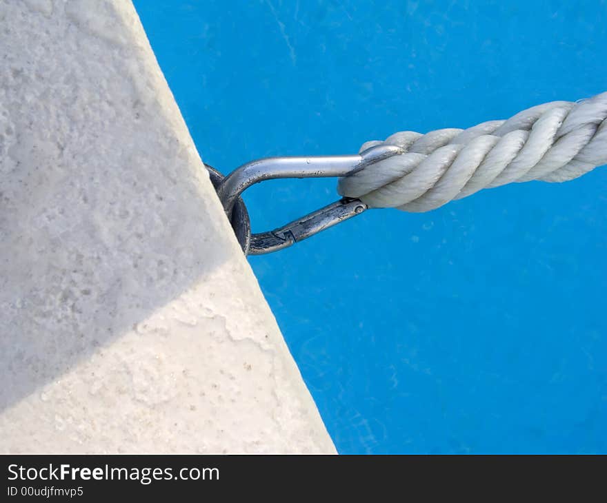 Detail of a rope and hook in the border of the pool